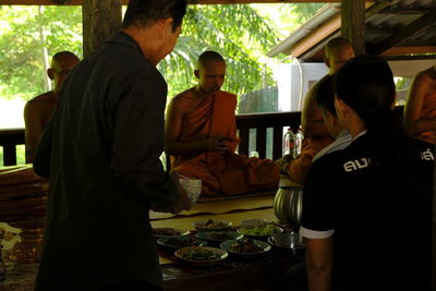 Rear view of people sitting at table