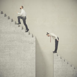 Man and woman standing on staircase