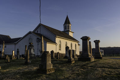 View of cemetery and building against sky