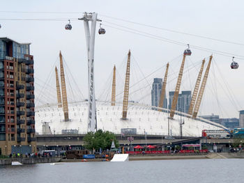 Sailboats in city against clear sky