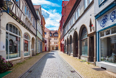 Empty street amidst buildings in city