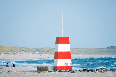 Lifeguard tower on beach against clear sky