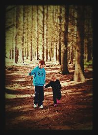 Rear view of boy standing in park