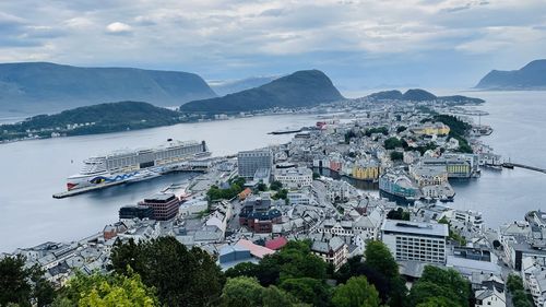 High angle view of townscape by sea against sky