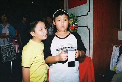 Portrait of cute girl standing by boy