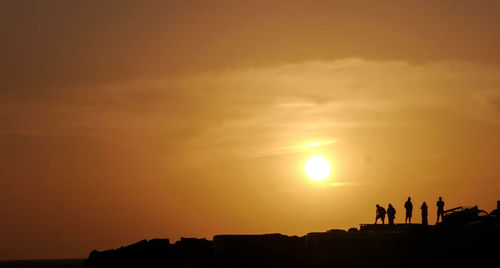 Silhouette of people at sunset