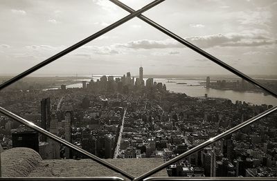 View of cityscape against cloudy sky