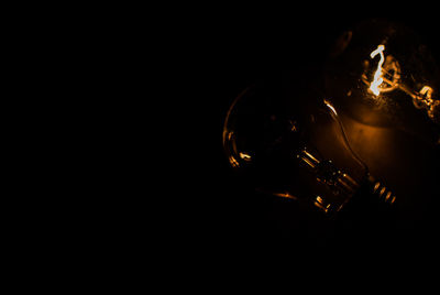 High angle view of illuminated light bulb against black background