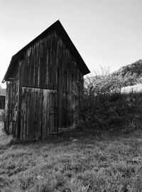 Abandoned building on field against clear sky