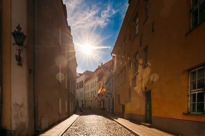 Street amidst buildings in city against sky