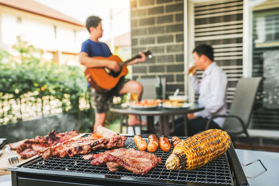 Man standing on barbecue grill