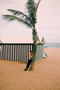 Woman walking on beach against sky