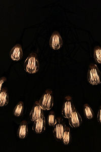 Low angle view of illuminated lanterns hanging at night