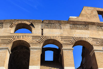 Low angle view of historic building against clear blue sky