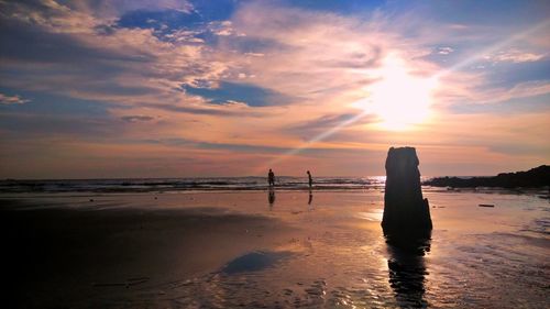 Scenic view of beach against sky during sunset