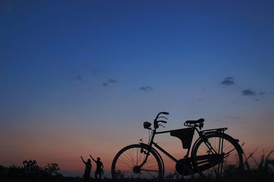 Silhouette bicycle against sky during sunset