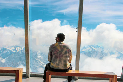 Rear view of woman looking at sea against sky