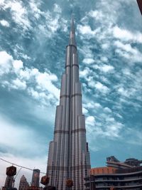 Low angle view of buildings against cloudy sky