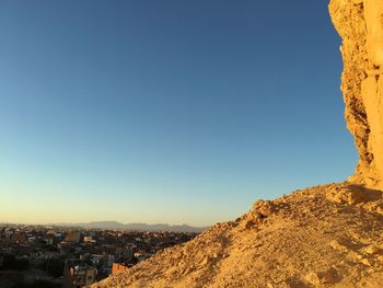 High angle view of buildings in city against clear blue sky