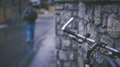 Close-up of bicycle against wall