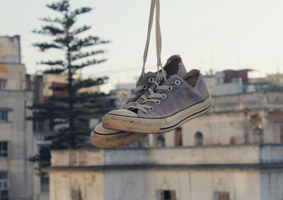 Close-up of shoes hanging on thread