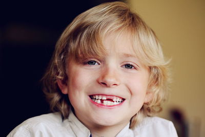 Portrait of gap toothed boy smiling at home