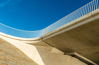 Low angle view of bridge against blue sky