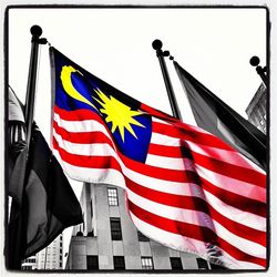 Low angle view of american flag against clear sky