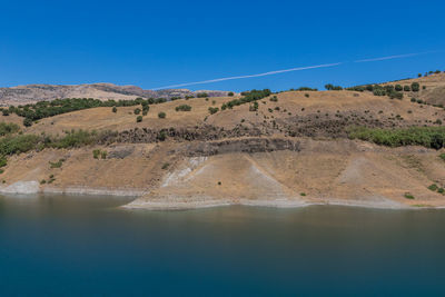 Scenic view of landscape against clear blue sky