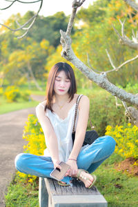 Young woman sitting on field