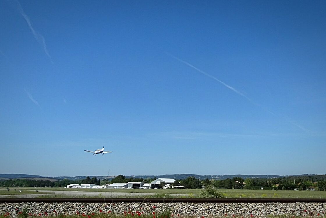 AIRPLANE FLYING ABOVE SKY