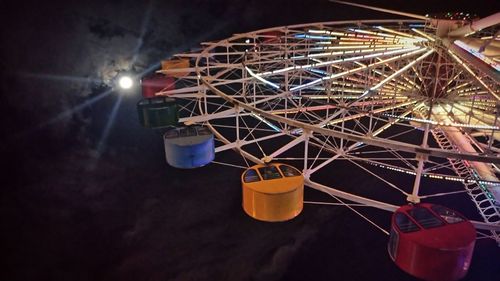 Low angle view of illuminated ferris wheel