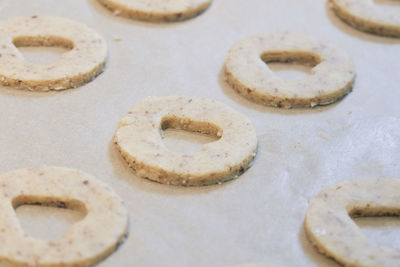 Close-up of raw biscuits on wax paper