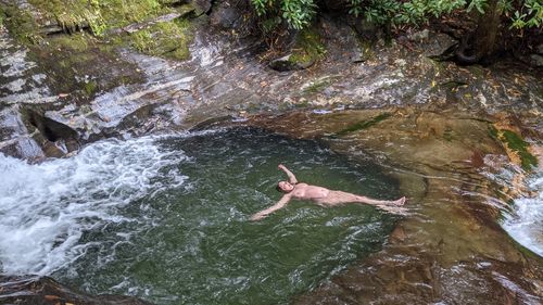 High angle view of woman swimming in river
