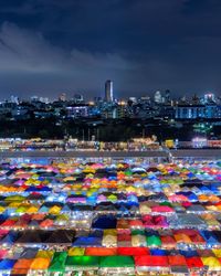 Illuminated cityscape against sky at night