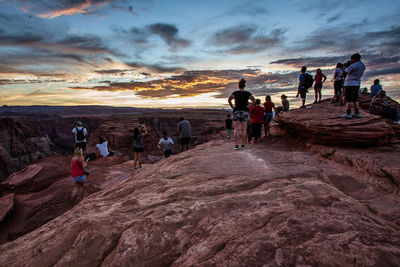 People on mountain at sunset