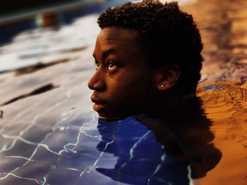 Portrait of boy looking at swimming pool