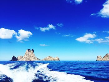 Scenic view of sea against blue sky