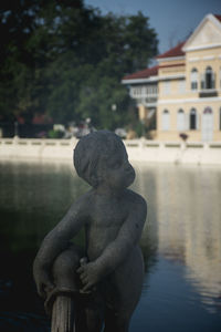 Statue of building against water