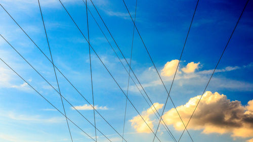 Low angle view of power lines against sky