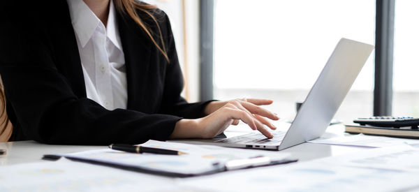 Midsection of business people working at office
