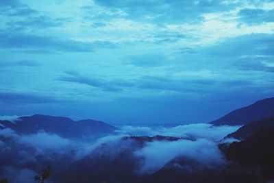 Scenic view of mountains against blue sky