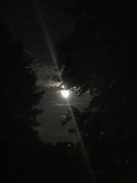 Low angle view of silhouette moon against sky at night