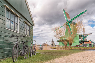 Traditional windmill on field against sky