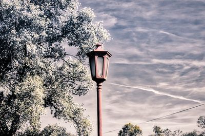 Low angle view of street light against cloudy sky