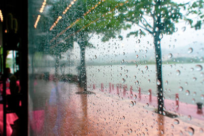 Full frame shot of wet glass window during rainy season