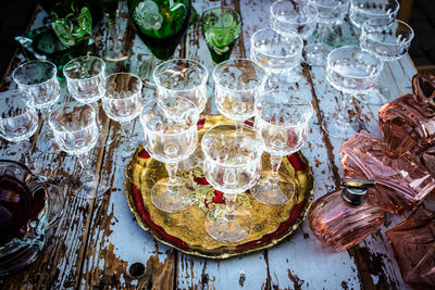 High angle view of glasses and bottles on table at market