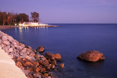 Rocks on sea shore against sky