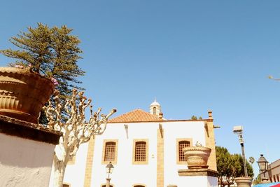 Low angle view of building against clear blue sky