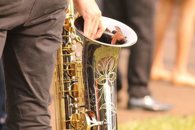 Midsection of man playing guitar